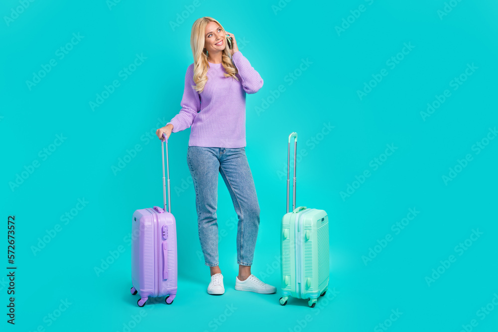 Full body portrait of nice cheerful lady speak communicate telephone airport suitcase isolated on turquoise color background Full body portrait of nice cheerful lady speak communicate telephone airport suitcase isolated on turquoise color background