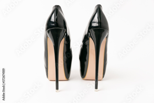 black shoes threesome strips on very high heels on a white background