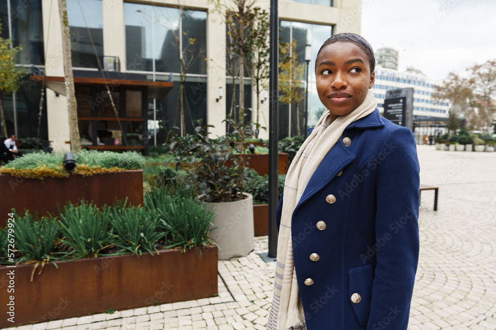 Portrait of smiling young black woman standing in the street Portrait of smiling young black woman standing in the street