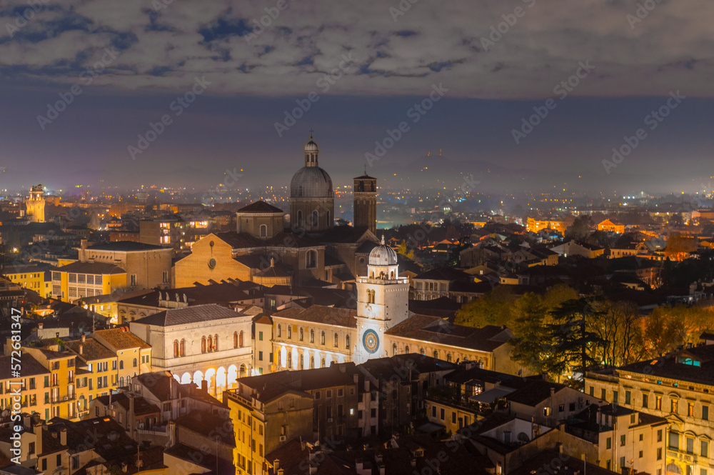 Padova city from above, night aerial view towards the cathedral and mountains