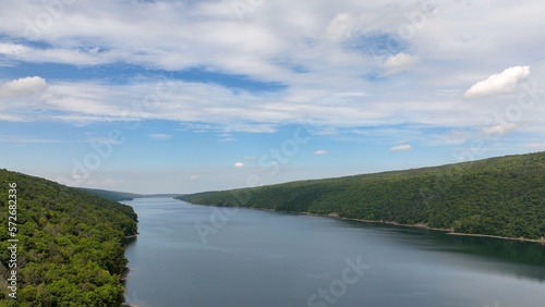 Hemlock Lake New York Finger Lake with blue sky and clouds and green mountains in Natural area