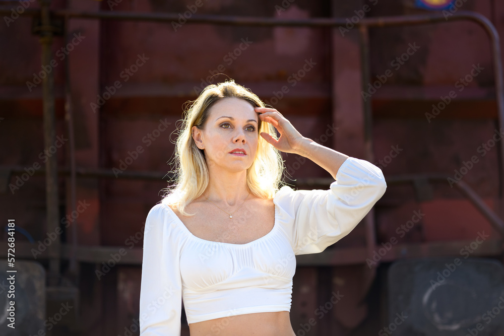 Fototapeta premium Sensual middle-aged woman running a hand through her hair