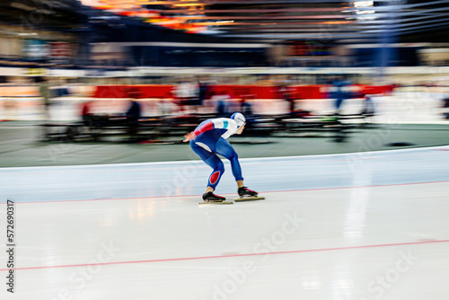 Obraz na plátně speed skating competition. motion blur speed skater athlete
