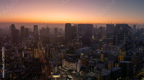 Modern city shrouded in atmospheric haze with first light of day on horizon