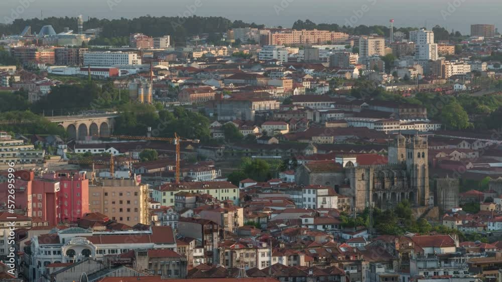 Aerial view to Rooftops of Porto's old town with the Cathedral on a warm spring day timelapse before sunset time with historic architecture, Porto, Portugal Aerial view to Rooftops of Porto's old town with the Cathedral on a warm spring day timelapse before sunset time with historic architecture, Porto, Portugal