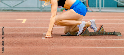 girl athlete runner in starting blocks race for sprint distance © sports photos