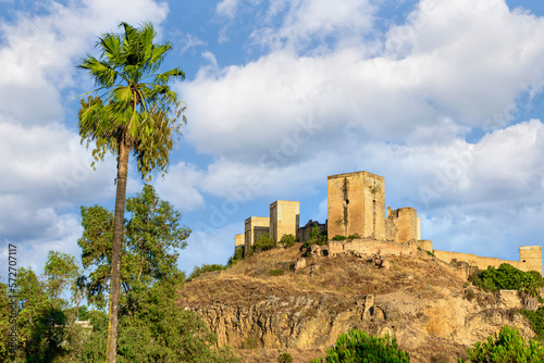 Views from the Parque de la Retama of the castle of Alcalá de Guadaira in Seville, in blue sky and white clouds	