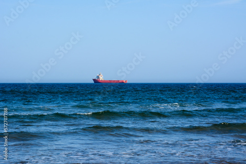 Sea view. Sea and sky panorama. Sea idyll. A lone freighter in the distance. Small sea waves