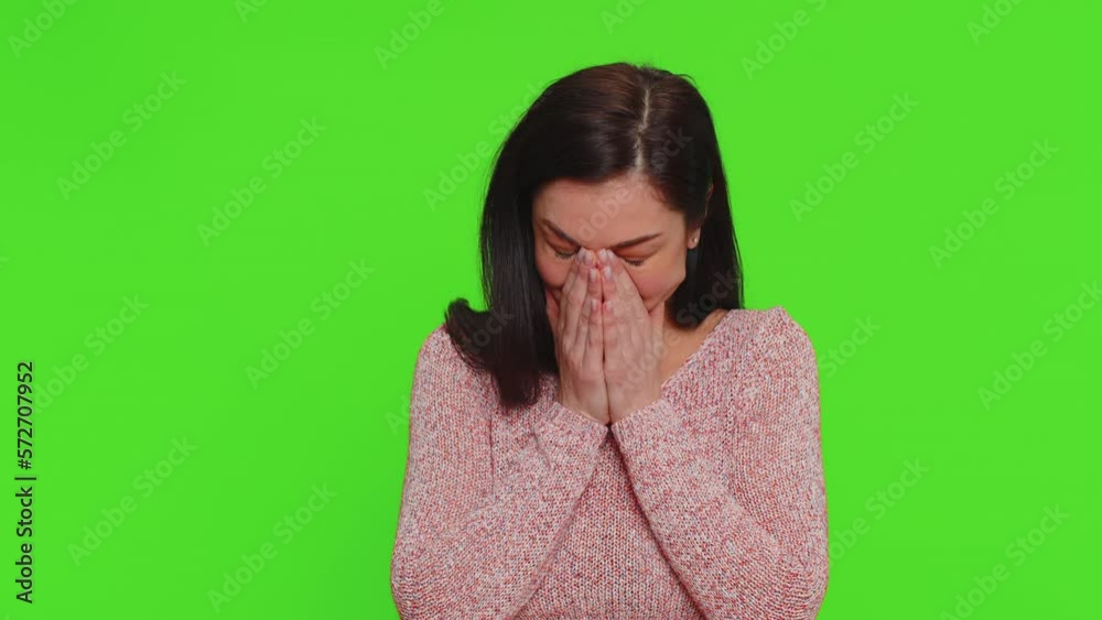 Upset disappointed pretty young woman wipes tears and cries from despair being sad because of unfair things. Millennial girl in depression, despair, loss isolated on green screen chroma key background Upset disappointed pretty young woman wipes tears and cries from despair being sad because of unfair things. Millennial girl in depression, despair, loss isolated on green screen chroma key background