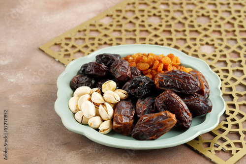 Various Snack for Sweet Takjil Iftar Moslem Ramadan Month, Pistachio, Dates Fruit, and Golden Raisin.