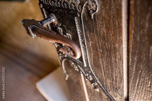 Shallow focus view of old medieval wooden door iron handle, Corvin Castle, or 