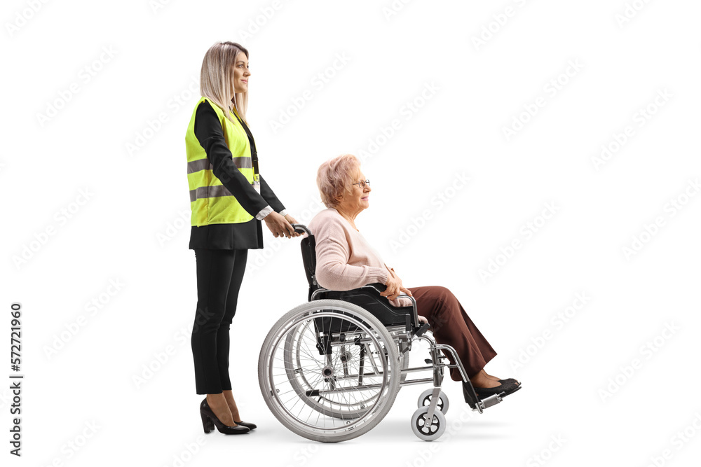 Special assitance worker standing behind a senior woman in a wheelchair Special assitance worker standing behind a senior woman in a wheelchair