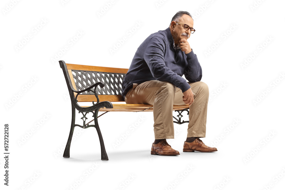 Pensive mature man sitting on a bench and thinking Pensive mature man sitting on a bench and thinking