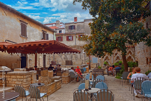 Fototapeta Naklejka Na Ścianę i Meble -  Medieval Croatian old street,with street cafe in Croatia, Istria