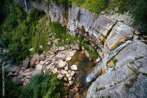 The Kinchkha waterfall in the canyon of the river Okatse. Rest in Georgia. High waterfall in the Imereti region. Rocky ledges of the mountain with green trees.