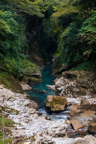 Beautiful natural canyon with view of the mountain river, christal blue water, green tree, Summer day time. Travel and active life style. Vacation. Martvili in Georgia near Kutaisi. Vertical photo photo