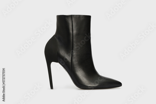 Black pointy toe women's ankle boots with high stiletto heels isolated on white background. Female classic, spring, autumn shoes. Blank casual leather footwear. Mock up, template © Olha