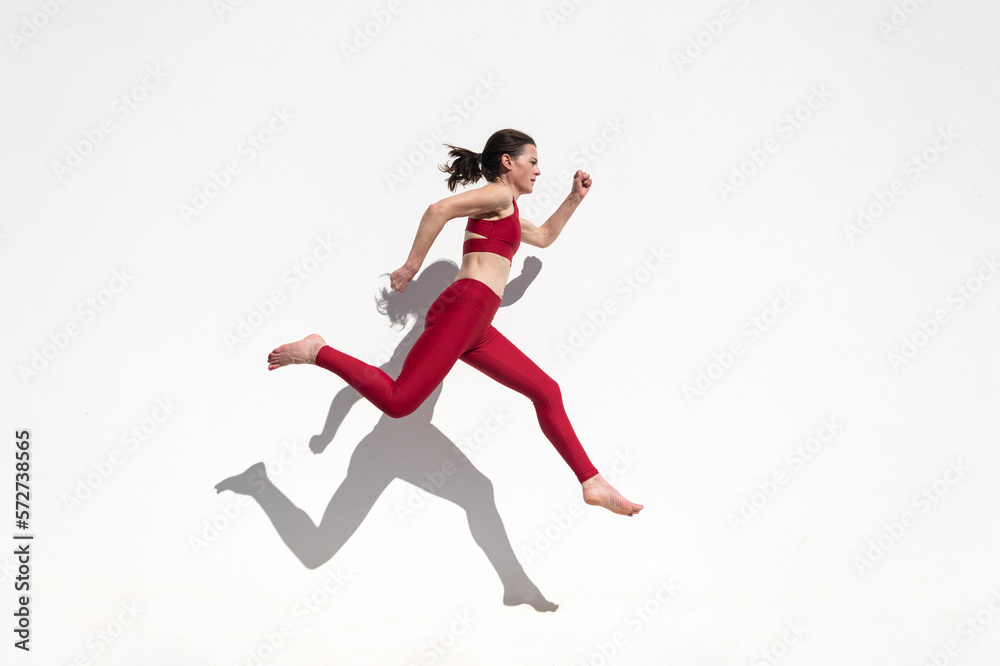 Sporty woman running and jumping