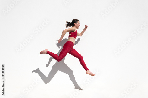 Sporty woman running and jumping