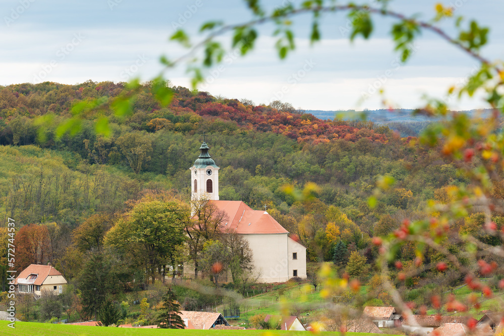 church in the middle of a village among colorful hills church in the middle of a village among colorful hills