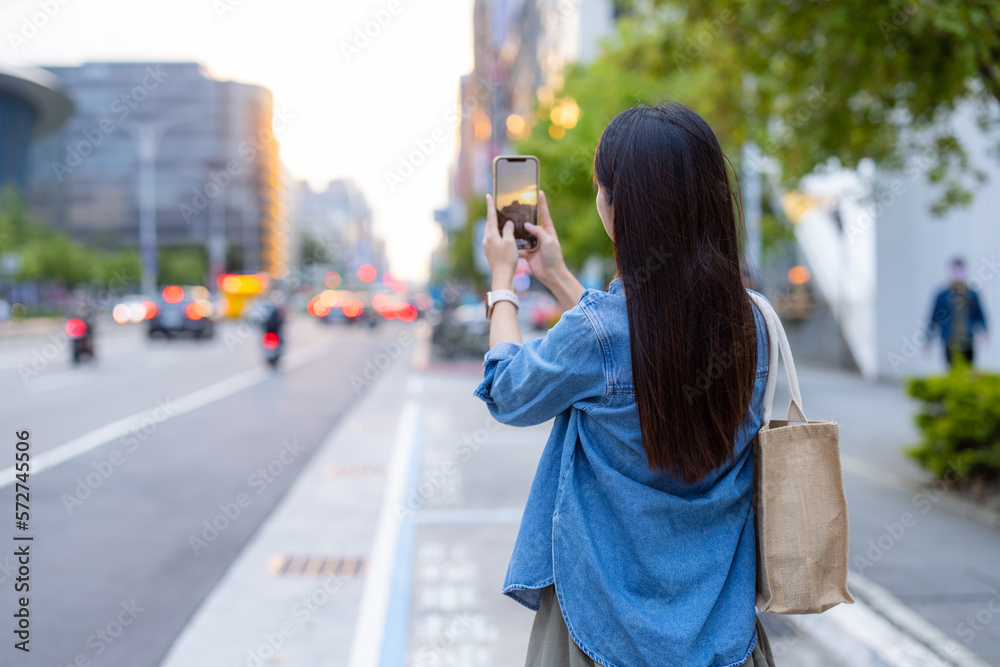 Woman take photo on the street in Taipei city Woman take photo on the street in Taipei city