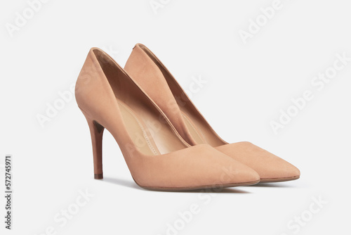 Beige pointy toe women's shoes with high heels isolated on white background. Female classic stiletto heels in suede leather. Mock up, template