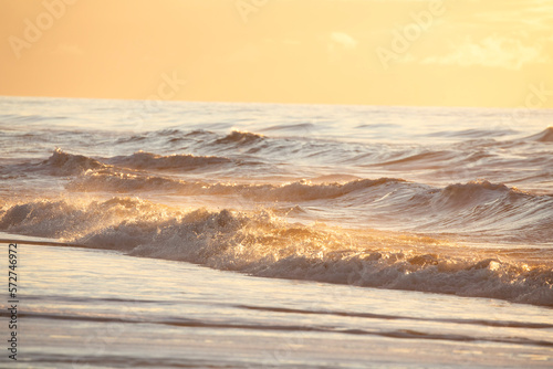 splashing waves in sunset light