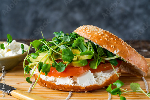 Canvas Print Vegetarian sesame bagel with cream cheese, tomato, avocado and watercress