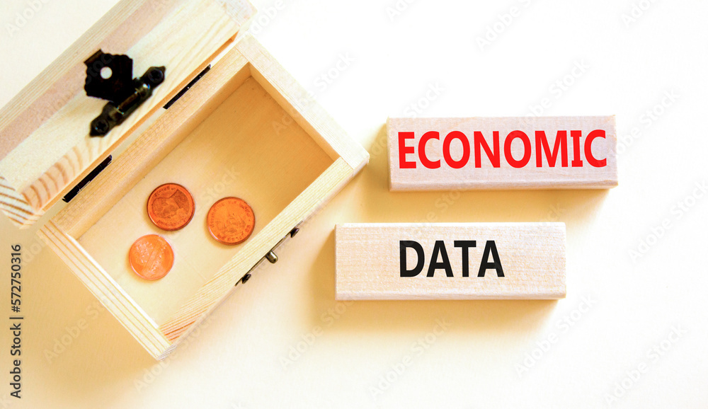 Economic data symbol. Concept words Economic data on wooden block. Beautiful white table white background. Wooden chest with coins. Business economic data concept. Copy space. Economic data symbol. Concept words Economic data on wooden block. Beautiful white table white background. Wooden chest with coins. Business economic data concept. Copy space.