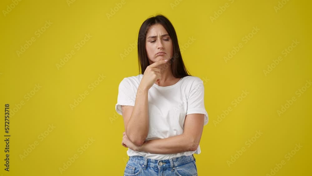 4k slow video of one girl thinking about something on yellow background. 4k slow video of one girl thinking about something on yellow background.