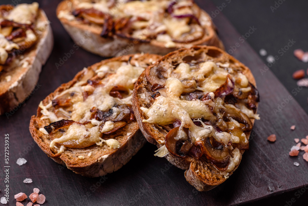Delicious crispy toast or bruschetta with fried onion, champignon mushrooms and cheese