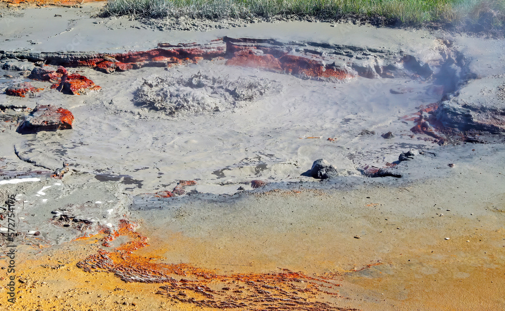 Seltun / Krysuvik geothermal area: Closeup of grey red boiling hot bubbling  steaming mud pot