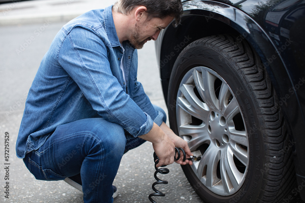 checking tire pressure with tire gauge standards