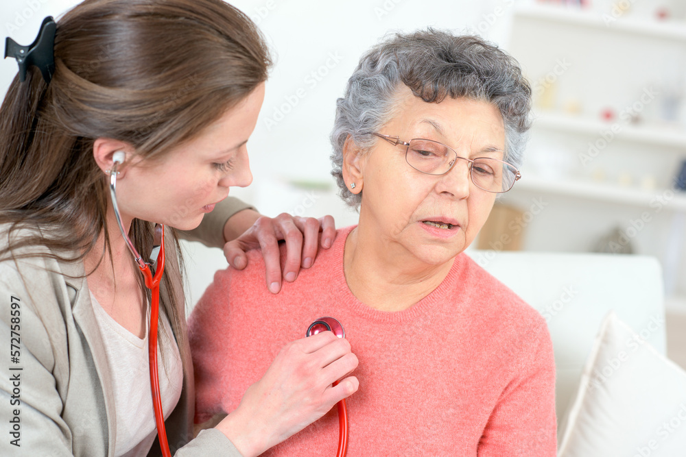 doctor examining blood pressure and heart rate on a senior