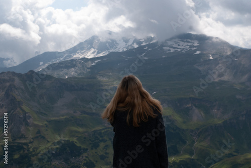 Girl on the background of mountains in Alps