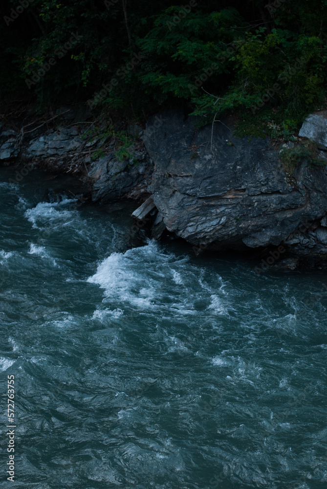 Mountain river with clear water near rock in Alps Mountain river with clear water near rock in Alps