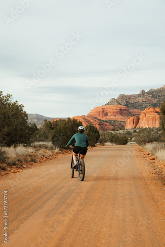 Young female girl riding mountain bike on forest service dirt road 525 at sunset in Red Rock wilderness coconino Sedona Arizona Southwest USA. © ArboursAbroad.com