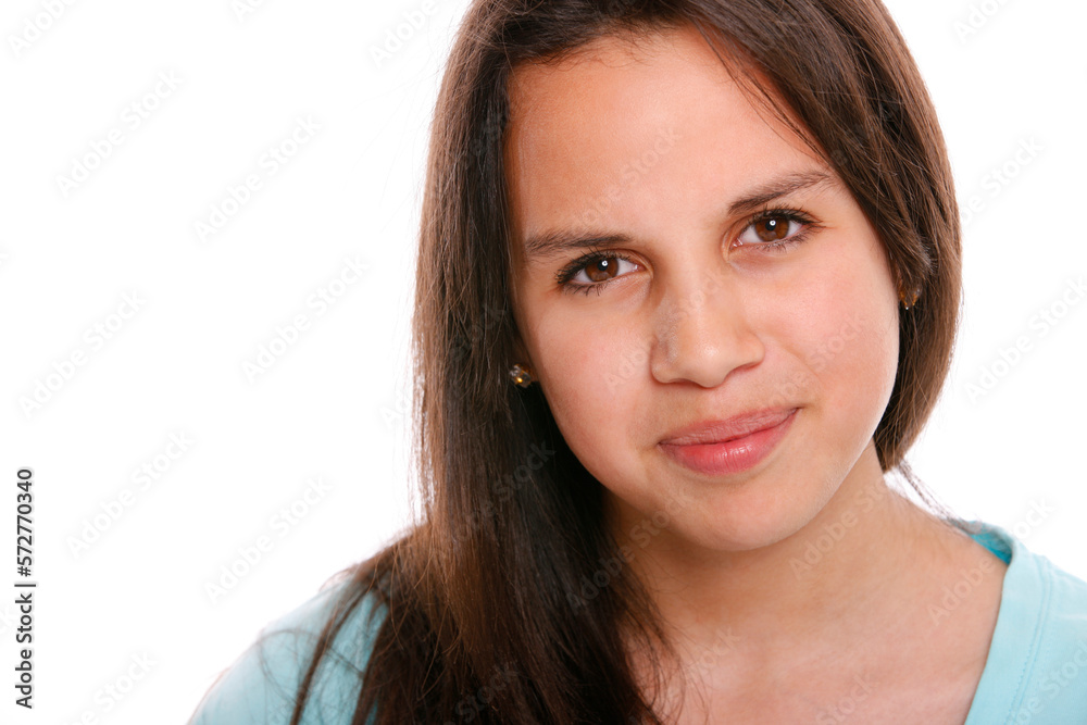 Studio portrait of teenage girl smiling in front of white background. Studio portrait of teenage girl smiling in front of white background.