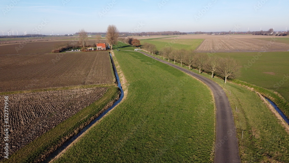 Farmland with farmer's farm. Drone aerial view panarama sight. Winter with landscape resting for the new season. Farmers live with small villages in the area.