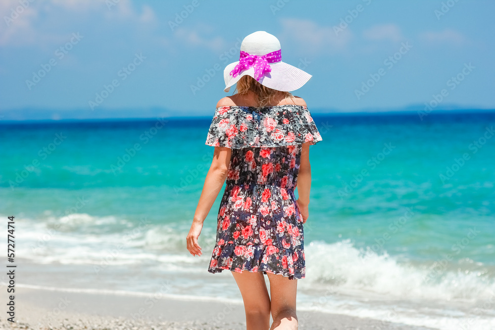 A Happy girl on the shore of the sea in travel vacation