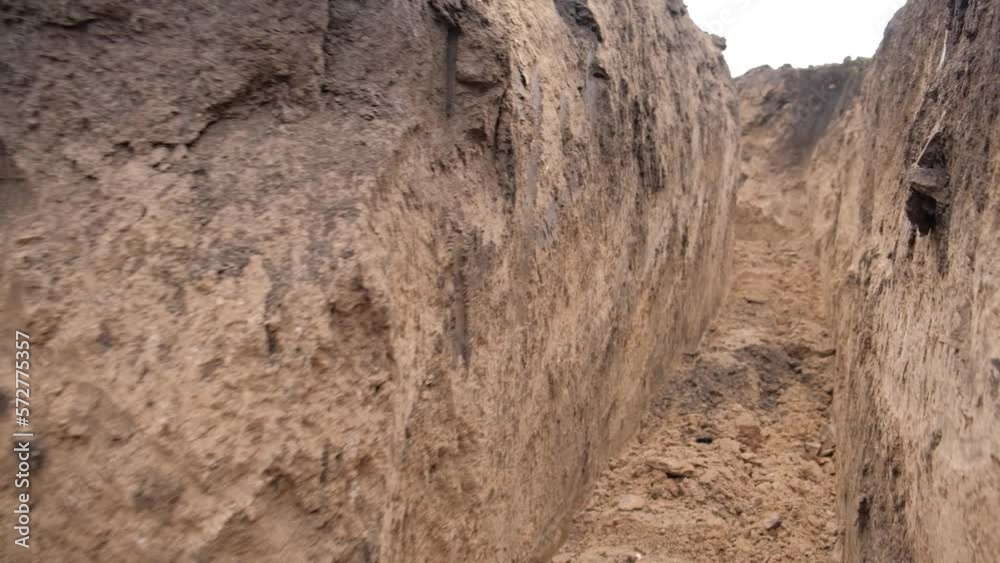 The movement of the bottom of the clay trenches that the excavator dug for the military. Russian-Ukrainian war 2022.