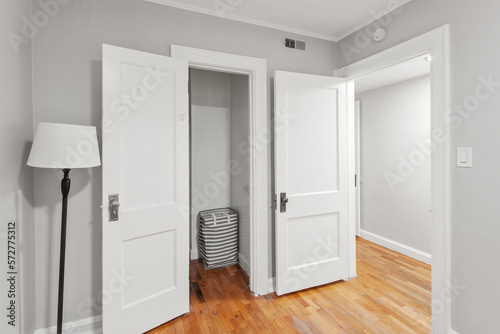 Large walk-in master bedroom closet in a new construction house with hardwood floors and wire shelving