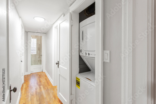 Stacked washer and dryer in laundry room in apartment