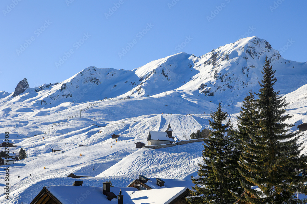 The famous swiss skiing resort Arosa in Canton Grison with large snow slopes and the oldest church Bergkirchli on the hill