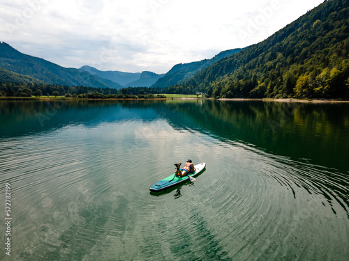 People Enjoying SUP Stand Up Paddle Boarding in Turquoise Waters in Austria