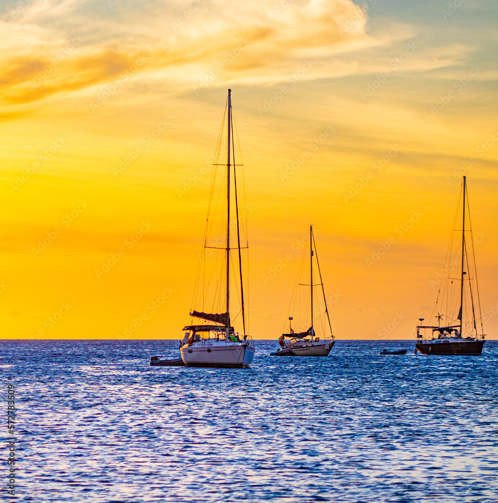 sailboats at sunset