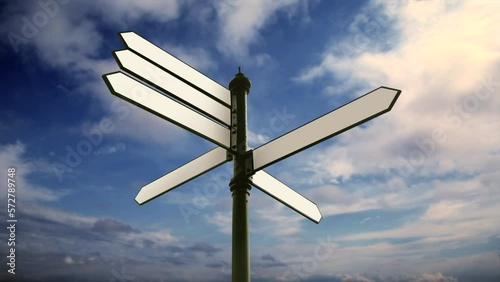 Blank directional signs over sunny blue sky photo