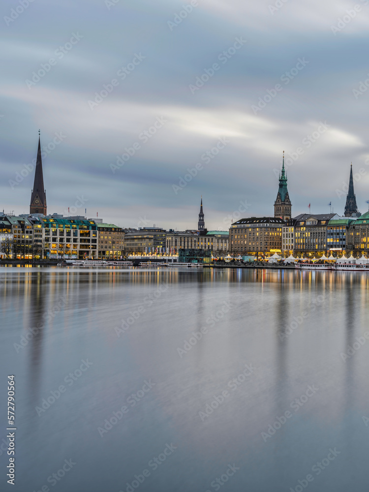 Hamburg city centre on lake Binnenalster after sunset with street lights, Germany Hamburg city centre on lake Binnenalster after sunset with street lights, Germany