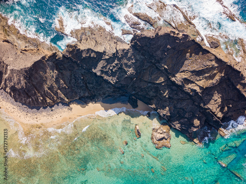 Brid's eye top view of Ilhéu da cal in Porto Santo Island. Golden sand and clear turquoise water