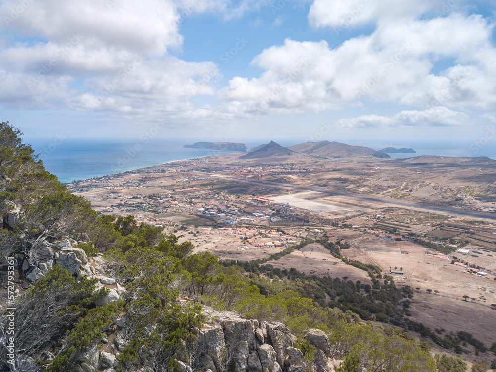 Drone top view from Pico do Castelo at Porto Santo facing the centre of the island - we can see the island airport and runway